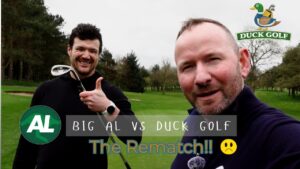 Two people standing on a golf course holding golf clubs, with on‑screen text reading ‘Big AL vs Duck Golf – The Rematch’ and a Duck Golf logo in the top right.